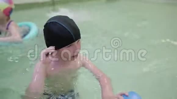 这个男孩学会在游泳池里游泳6岁的男孩在幼儿园的室内游泳池游泳视频的预览图