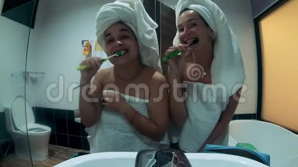 两位女士刷牙时大笑的正面景色视频的预览图