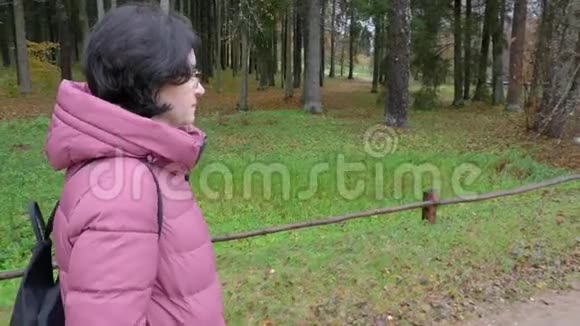 一位中年白种人妇女在森林中行走的时间流逝视频的预览图