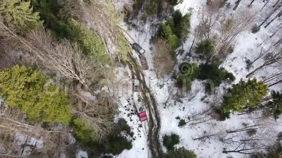 一群越野车站在山上一片森林一条雪道上视频的预览图
