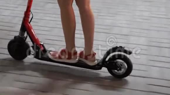 女孩骑电动滑板车和跟随男孩停车视频的预览图