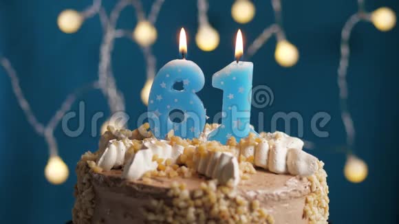 生日蛋糕有61号蜡烛在蓝色的背景上蜡烛吹灭了慢动作和特写视频的预览图