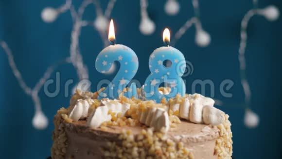 生日蛋糕蓝色背景上有28个数字蜡烛蜡烛吹灭了慢动作和特写视频的预览图