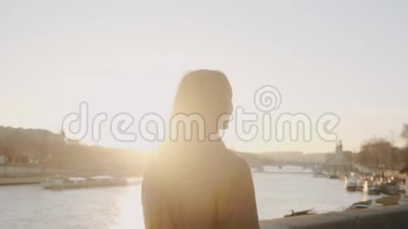 后景幸福美丽的女人沿着史诗般的日落塞纳河畔漫步浪漫的巴黎度假慢动作视频的预览图
