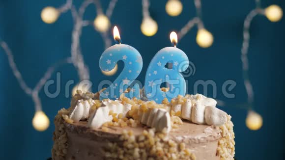 生日蛋糕蓝色背景上有26支蜡烛蜡烛吹灭了慢动作和特写视频的预览图