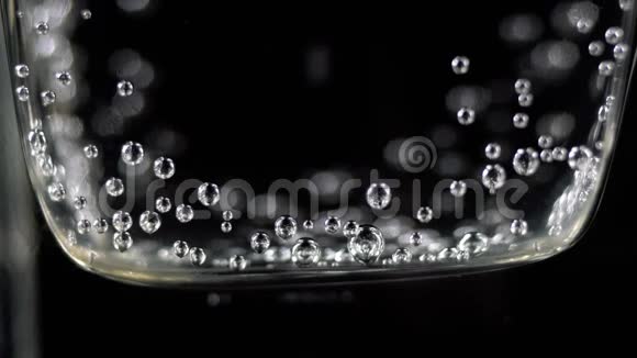 关闭玻璃中的矿泉水气泡黑暗中装有氧气球的碳酸新鲜汽泡饮料宏店视频的预览图