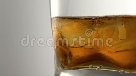一杯加冰块的陈年金威士忌酒吧里有石头的琥珀色酒精饮料视频的预览图