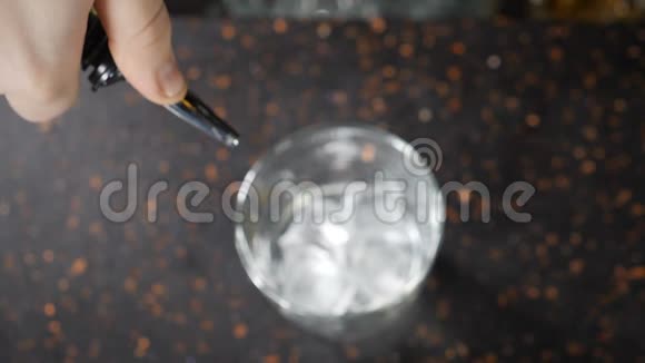 酒保和酒吧的概念用冰块准备酒精饮料加冰的杯子饮用含酒精的饮料视频的预览图