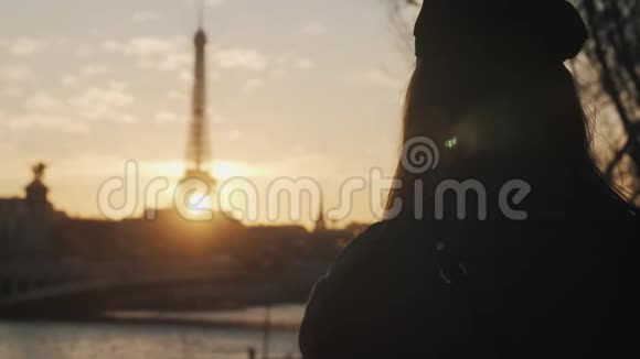 后景快乐体贴的博客女性与相机观看史诗般的日落埃菲尔铁塔在秋天巴黎慢动作视频的预览图