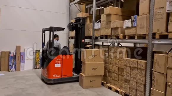 一个工人在仓库商店里用叉车搬运纸箱工业运输概念视频的预览图