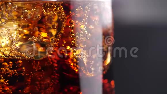冰和泡泡的可乐冷可乐杯冰旋转慢动作视频的预览图