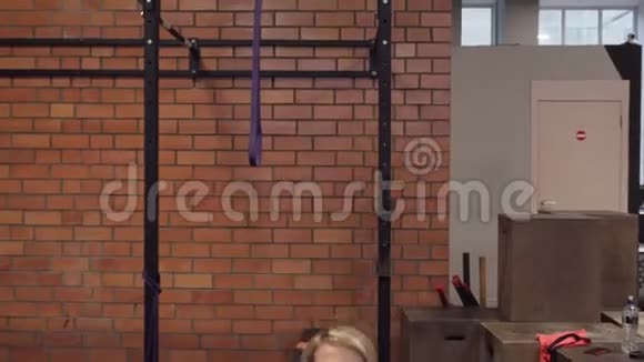 在健身房做哑铃推进器运动的女人视频的预览图