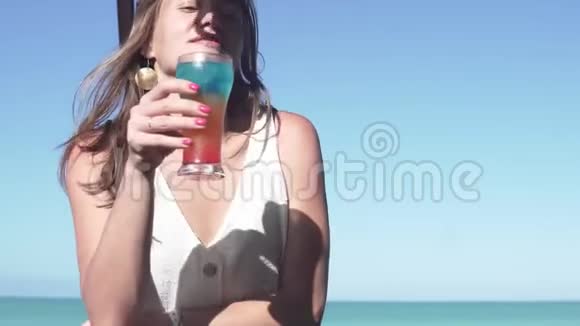 一位女游客在古巴海边的酒吧喝一杯鸡尾酒视频的预览图