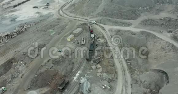 重型设备在一个巨大的露天矿里挖掘和牵引矿石视频的预览图