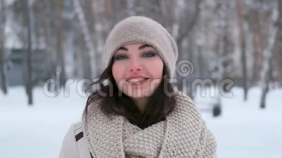 冬天森林里一个微笑的年轻女孩的肖像视频的预览图