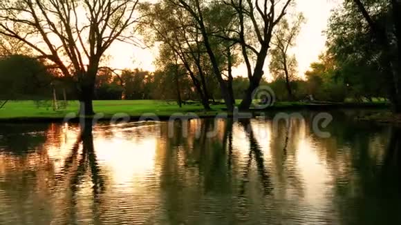 在公园的一个美丽的湖上日落照相机飞过水面视频的预览图