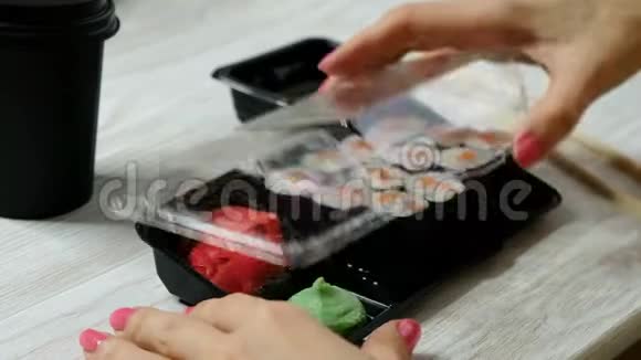 女人打开带卷寿司的格子盒子关上提供食物的概念视频的预览图