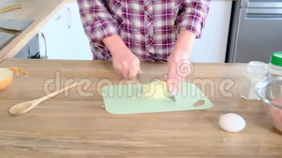 家庭主妇把洋葱切成小块女人在盘子里加入洋葱视频的预览图