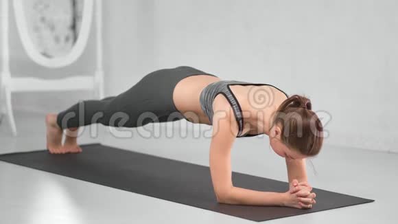 裸脚健身妇女站在垫子上晨练视频的预览图