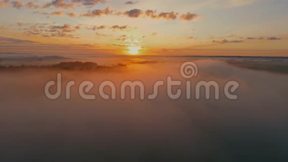 一架照相机慢慢地飞过雾气空中拍摄的晨雾笼罩湖面静静的云飞过镜头视频的预览图