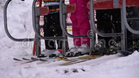 滑雪者通过滑雪电梯的旋转门滑雪椅带滑雪板的入口慢动作视频的预览图