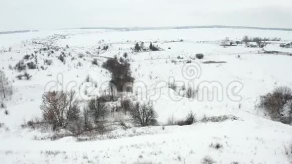空中视频飞过一个积雪覆盖的乡村墓地位于峡谷边缘视频的预览图