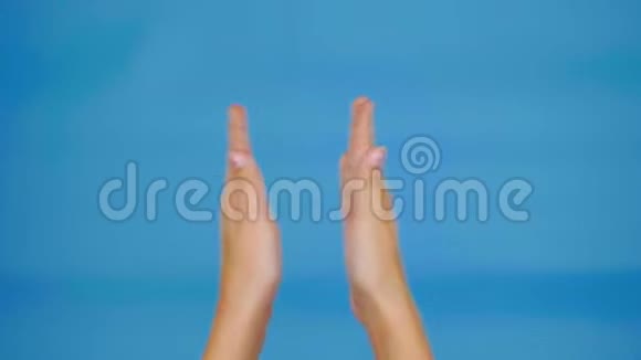 女性的手拍在蓝色背景上带有复制空间视频的预览图