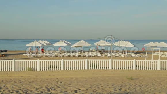 沙滩黎明时有躺椅和遮阳伞视频的预览图