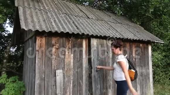 一个背着背包的女孩打开一个装满干草的谷仓视频的预览图