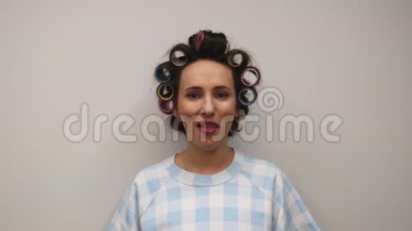 女孩嚼泡泡糖有着明亮妆容和粉红色嘴唇的女性在白色的墙壁上嚼口香糖视频的预览图