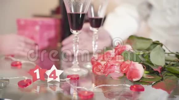 玻璃桌上摆着一束玫瑰和酒杯成熟的男人用手掌高级妻子视频的预览图
