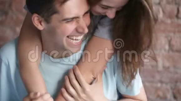 年轻的笑对情侣拥抱在一起一起玩看着镜头视频的预览图