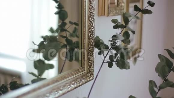 从花束和叶子中提取出来的花被反射到镜子里镜框的背景上有肖像视频的预览图