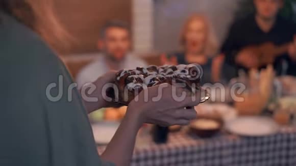 一个白种人女人端上桌子的蛋糕朋友或邻居一起庆祝节日视频的预览图