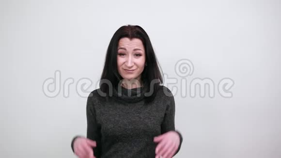 时尚黑色毛衣中的失望女人张开双手看上去不开心视频的预览图