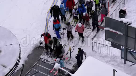 滑雪电梯上的队列旋转门的滑雪者队伍和人群视频的预览图