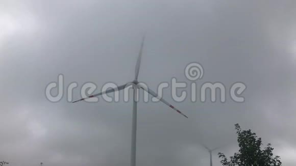 多云天空背景下的风力涡轮增压农业领域生产清洁可再生能源的风力涡轮机视频的预览图