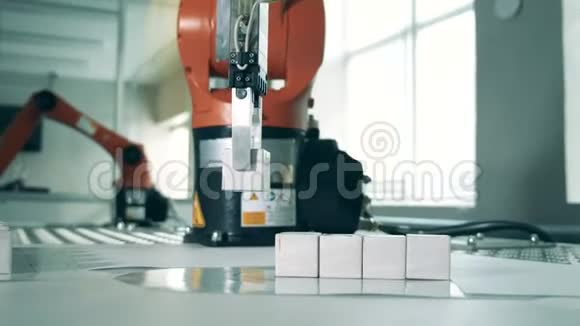 小立方体正被机器人手臂排成一排工业机械手视频的预览图