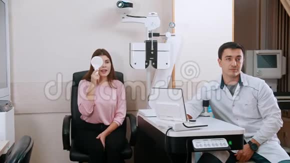 眼科治疗年轻女性检查视力闭上眼睛和读信一位坐着的医生视频的预览图