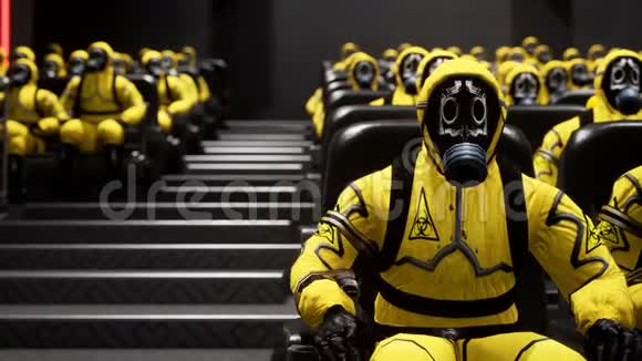 穿黄色防护服的人坐在电影院等电影有细菌保护的人视频的预览图
