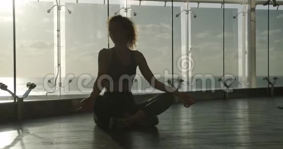 年轻漂亮的女人在训练中冥想做瑜伽的运动女孩视频的预览图