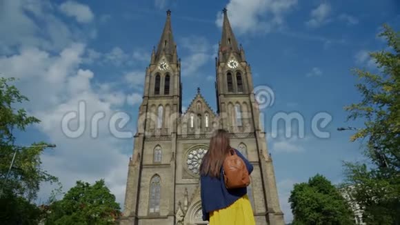 旅游女孩看着宏伟的圣路德米拉教堂蓝天从背面俯视和平广场视频的预览图