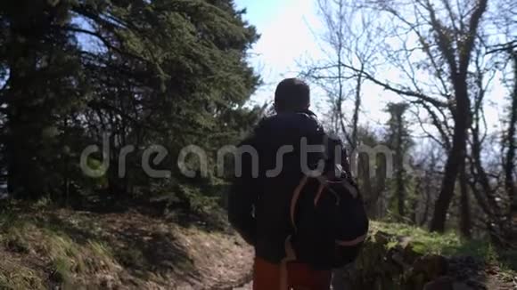 穿着夹克的游客沿着古老的岩石小径漫步视频的预览图