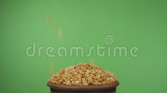 豆粒掉进拥挤的泥碗里从里面掉出来孤立在绿色屏幕上视频的预览图