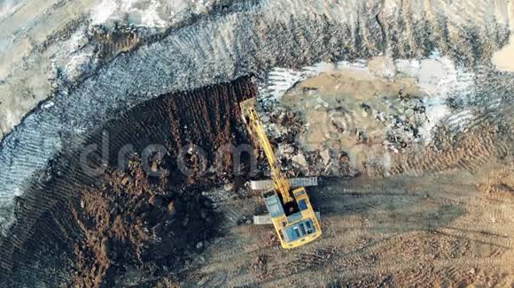 铲土机在采石场重新定位土壤的俯视图视频的预览图