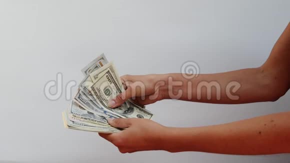 女性手握着一大笔钱重新定义它们近距离观看白色背景关注女性双手其中视频的预览图