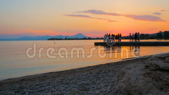 日落海滩派对夕阳背景与青春在码头日落海滩派对海边的户外派对视频的预览图