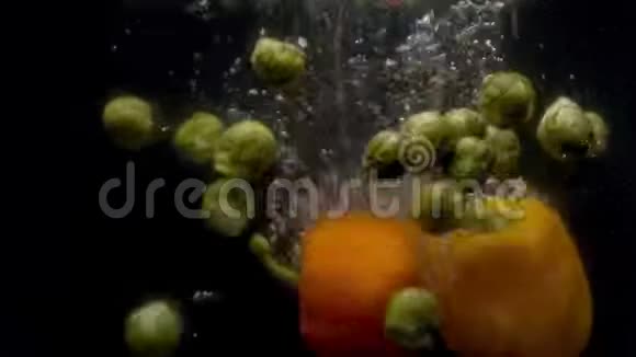 甘蓝和辣椒落入水中溅起水花和气泡视频的预览图