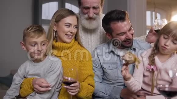 感恩节庆祝活动中可爱的一家人带着可爱的微笑一起在餐桌上玩得很开心视频的预览图