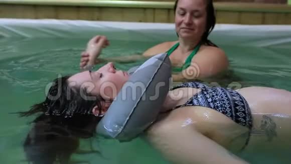 孕妇与教练一起游泳视频的预览图